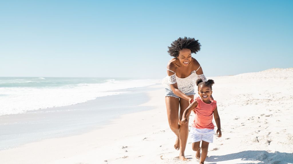 african-mother-running-after-her-daughter-on-the-beach
